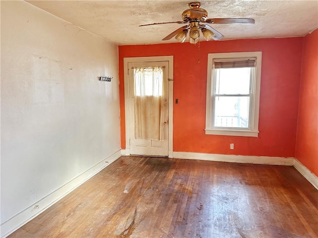 interior space featuring ceiling fan, hardwood / wood-style floors, and a textured ceiling