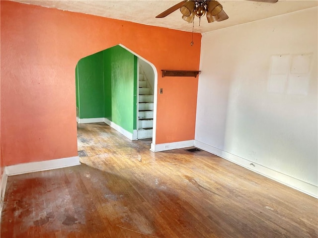 unfurnished room featuring ceiling fan and hardwood / wood-style flooring