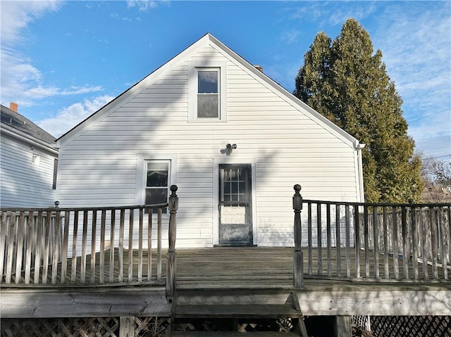 back of property with a wooden deck