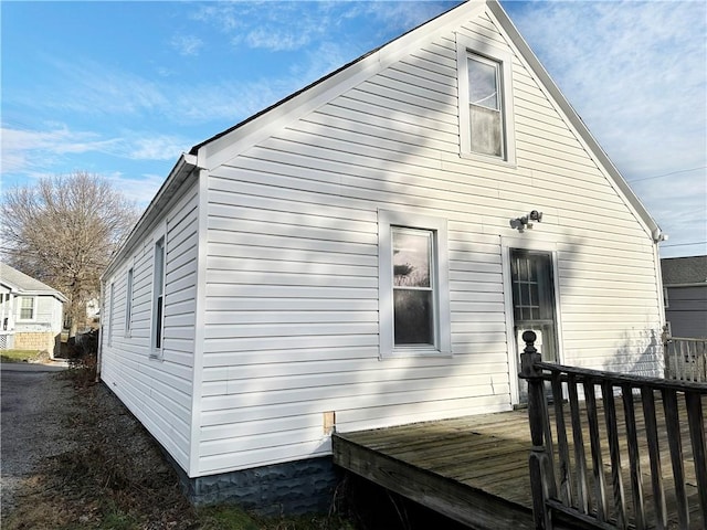 back of property featuring a deck