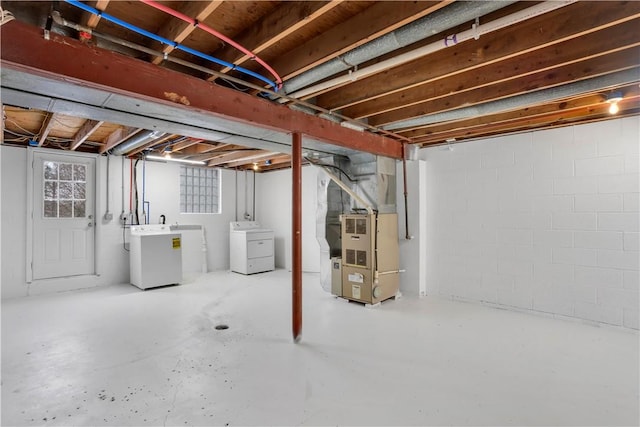 basement featuring heating unit and washer and dryer