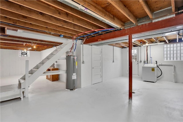 basement featuring washer / clothes dryer and water heater