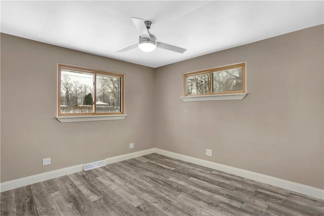 spare room with ceiling fan and wood-type flooring