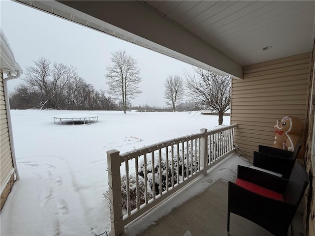 view of snow covered back of property