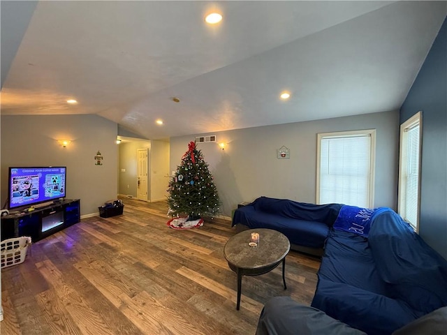 living room featuring hardwood / wood-style flooring and vaulted ceiling