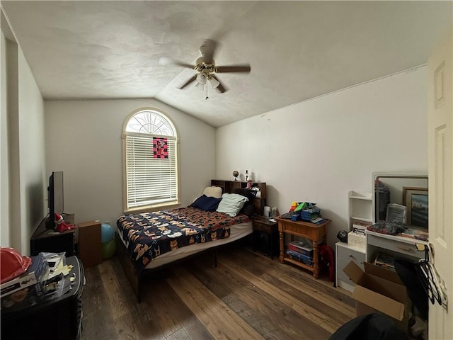 bedroom with ceiling fan, lofted ceiling, and dark hardwood / wood-style floors