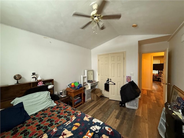 bedroom with vaulted ceiling, a closet, ceiling fan, and dark hardwood / wood-style flooring