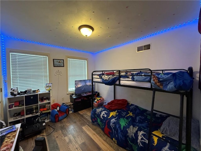 bedroom with hardwood / wood-style flooring