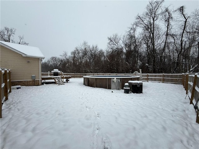 yard covered in snow featuring a fenced in pool