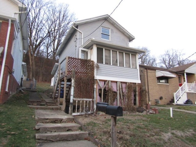 view of front facade featuring a sunroom