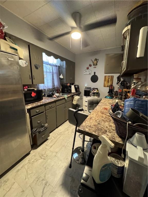 kitchen with ceiling fan and stainless steel refrigerator