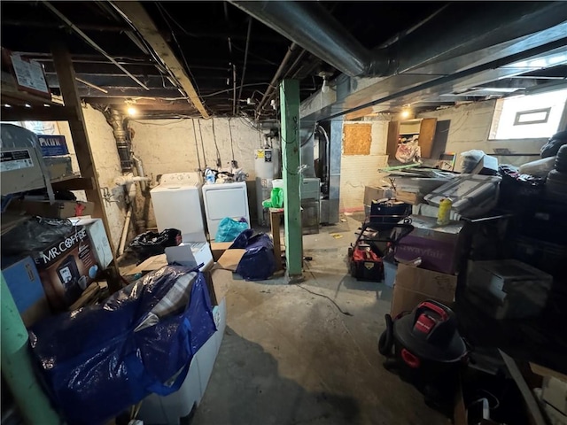 basement with washer and clothes dryer, heating unit, and water heater