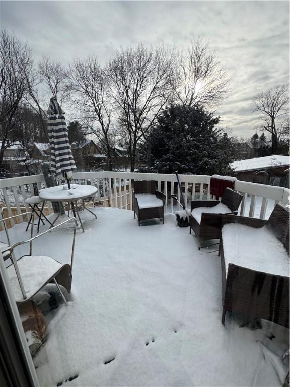 snow covered patio featuring a wooden deck