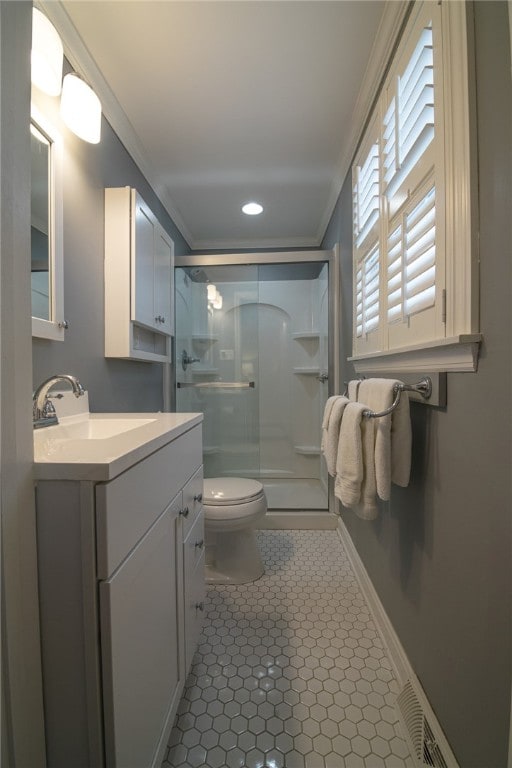 bathroom with toilet, an enclosed shower, ornamental molding, and vanity