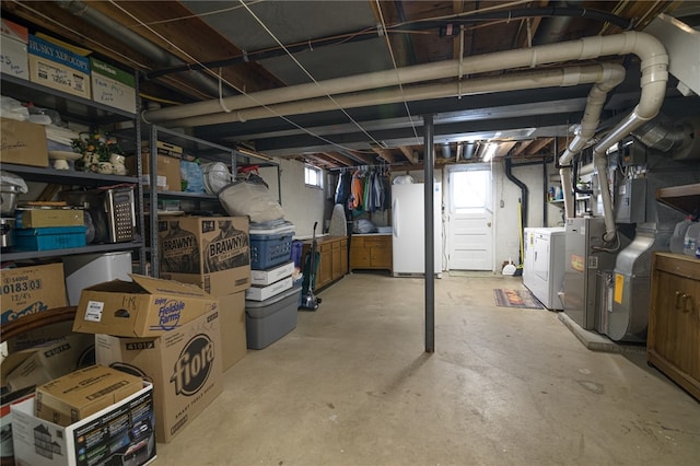 basement featuring white refrigerator and washer and clothes dryer