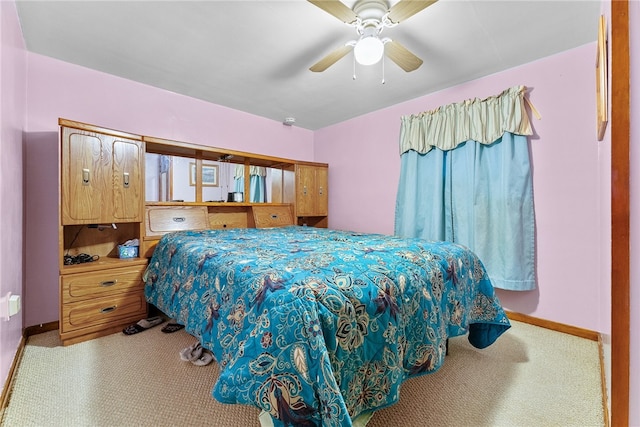 bedroom featuring light colored carpet and ceiling fan