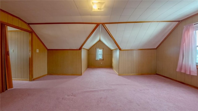 bonus room featuring wood walls, light carpet, and lofted ceiling