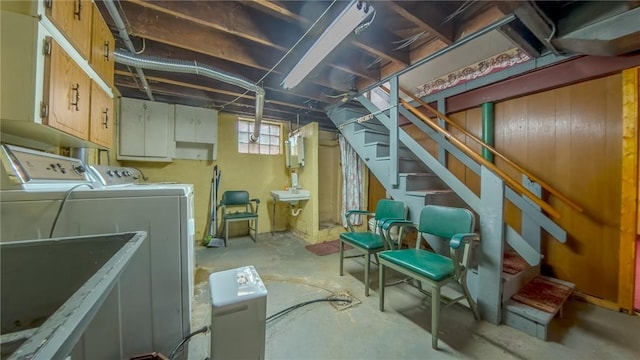 basement featuring separate washer and dryer and sink