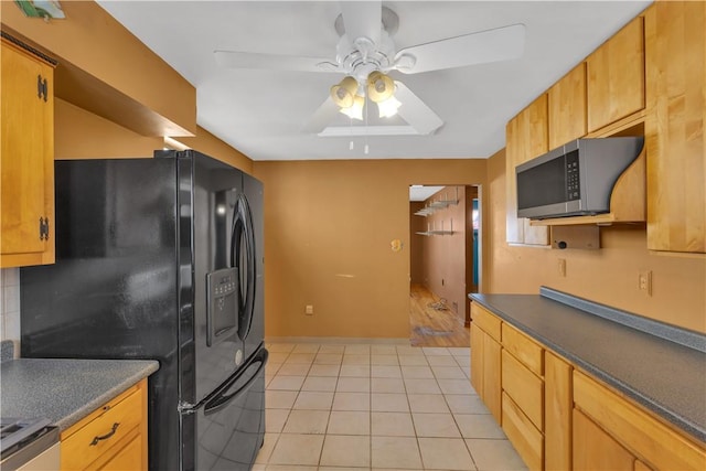 kitchen with ceiling fan, decorative backsplash, black refrigerator with ice dispenser, stove, and light tile patterned flooring