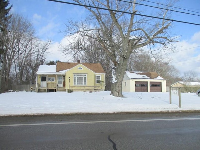 view of front of house featuring a garage and an outdoor structure