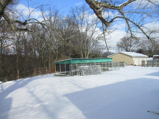 yard covered in snow featuring an outdoor structure