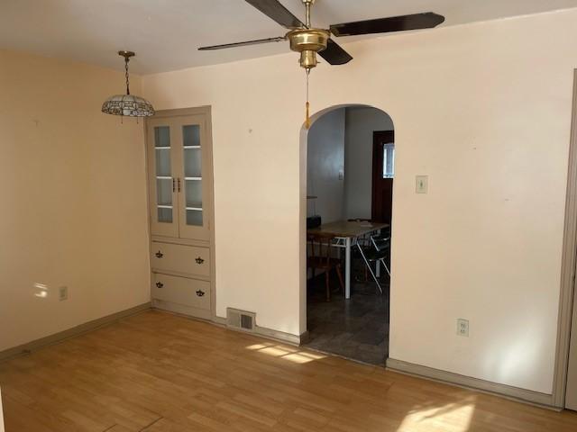 unfurnished room featuring ceiling fan and light hardwood / wood-style flooring