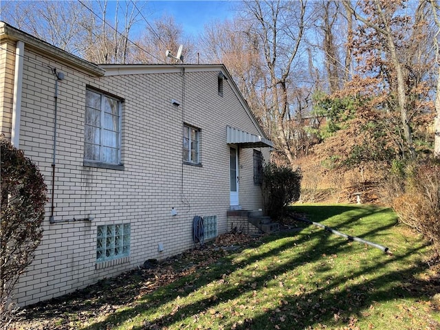 view of side of home featuring a lawn