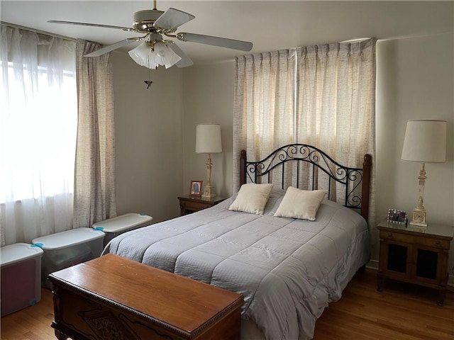 bedroom with ceiling fan and light hardwood / wood-style flooring