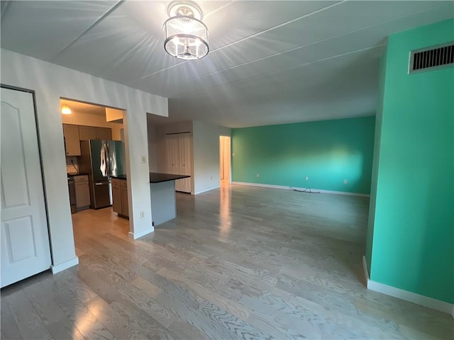 unfurnished living room with wood-type flooring