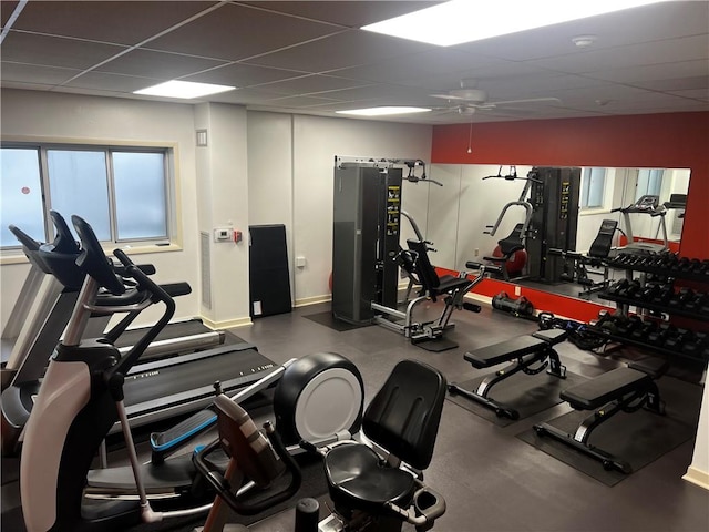 gym featuring ceiling fan and a drop ceiling