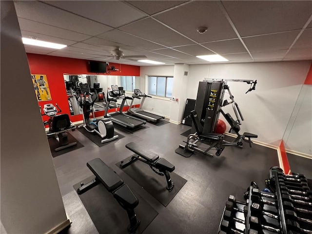 gym featuring ceiling fan and a drop ceiling