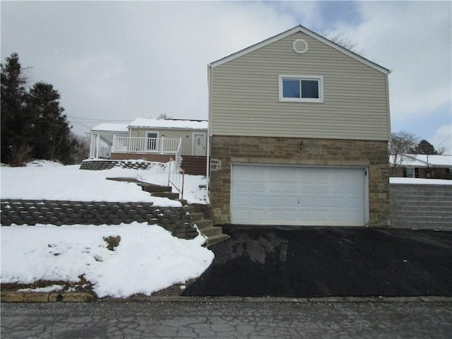 snow covered property featuring a garage