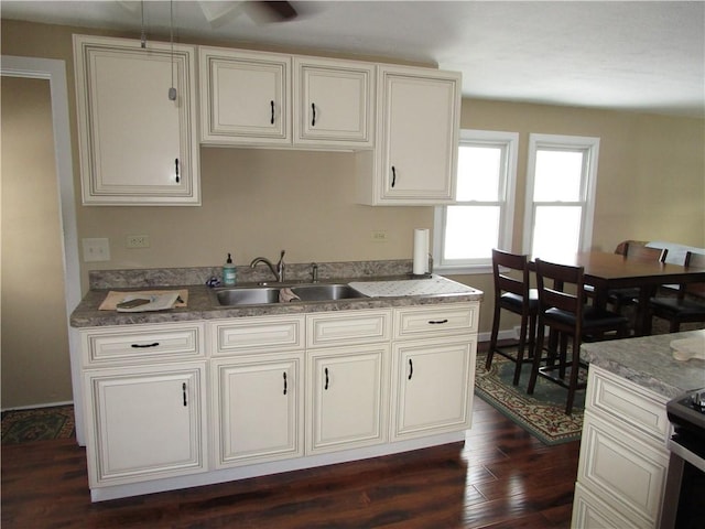 kitchen featuring stainless steel electric range oven, dark hardwood / wood-style floors, and sink