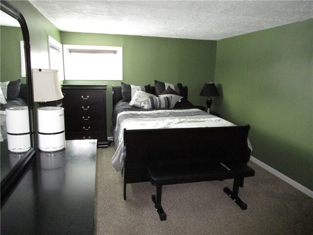 carpeted bedroom featuring a textured ceiling