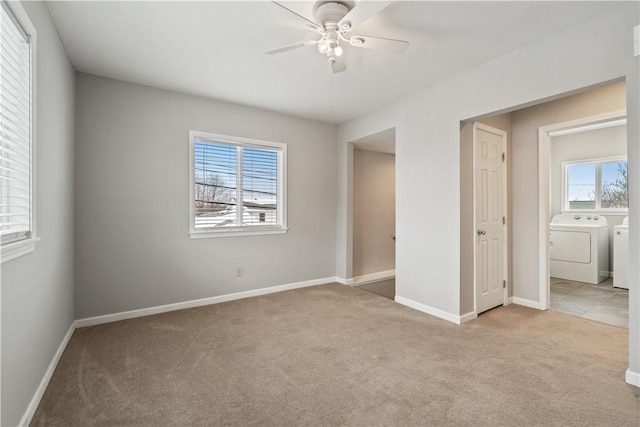 unfurnished bedroom with multiple windows, ceiling fan, separate washer and dryer, and light colored carpet