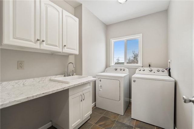 washroom featuring washer and dryer, cabinets, and sink