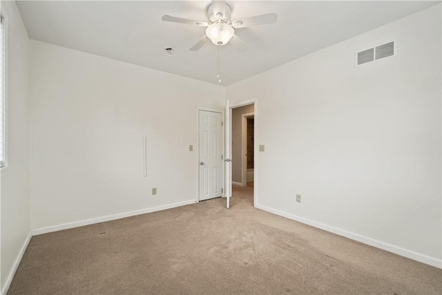 spare room with ceiling fan and carpet flooring