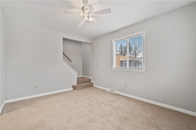 carpeted empty room featuring ceiling fan