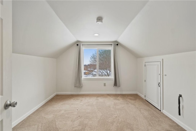 additional living space featuring light carpet and lofted ceiling