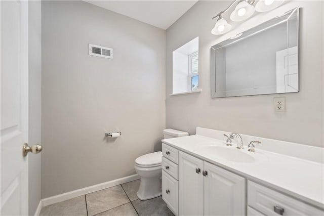 bathroom featuring vanity, tile patterned floors, and toilet