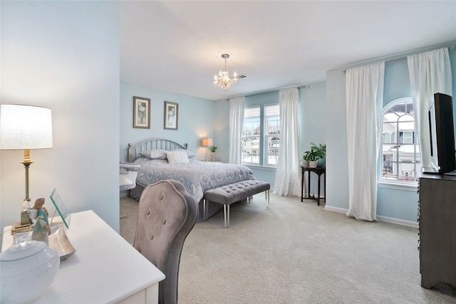 bedroom with an inviting chandelier and light colored carpet