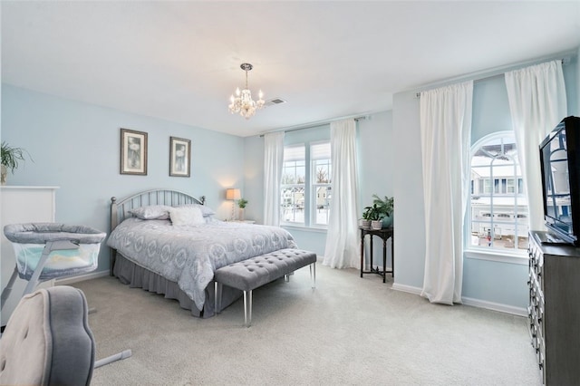 bedroom with light carpet and a notable chandelier