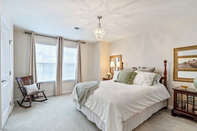 bedroom featuring light carpet and a chandelier