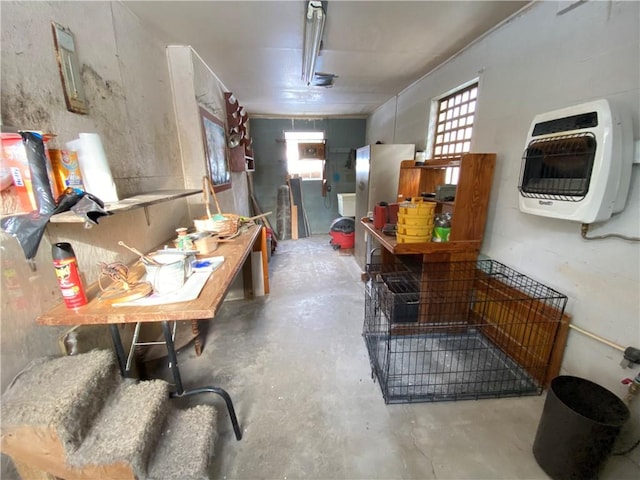 miscellaneous room featuring concrete floors and heating unit