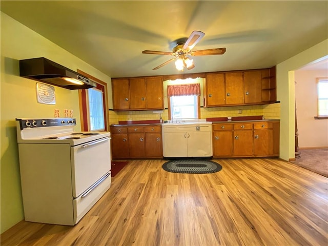 kitchen with light hardwood / wood-style flooring, exhaust hood, decorative backsplash, white electric stove, and ceiling fan