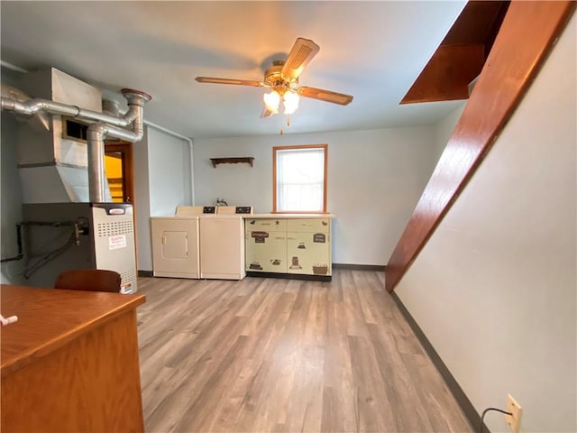 interior space featuring washer and clothes dryer, ceiling fan, and light hardwood / wood-style flooring