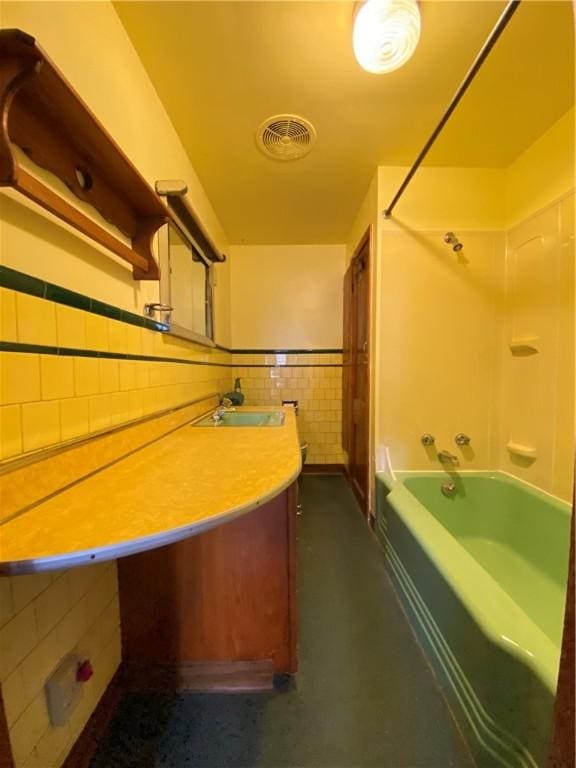 bathroom with tile walls,  shower combination, and vanity