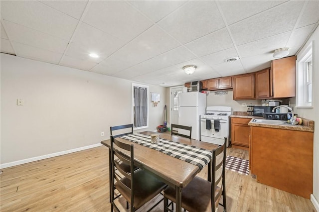 841 Brackenridge Ave, Brackenridge, PA 15014 - kitchen with sink, white appliances, a paneled ceiling, and light hardwood / wood-style floors