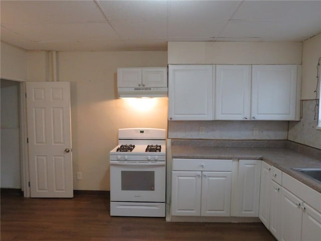 kitchen featuring white cabinets, dark wood-type flooring, and gas range gas stove