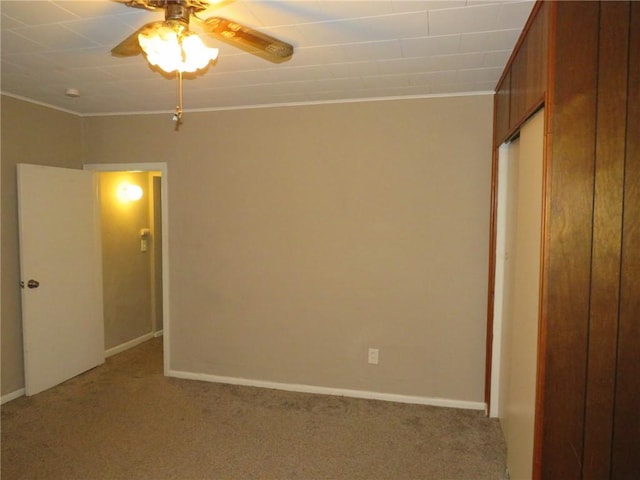 spare room featuring light carpet and ceiling fan